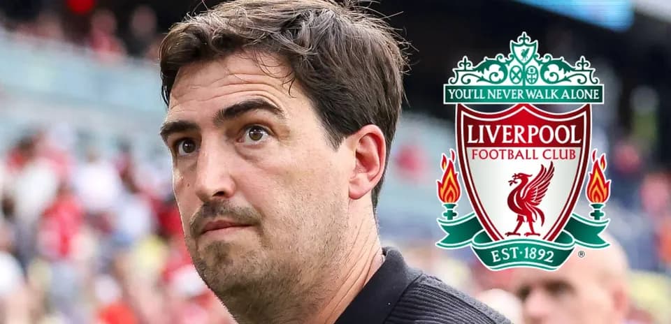 Coach in front of Liverpool FC logo at stadium