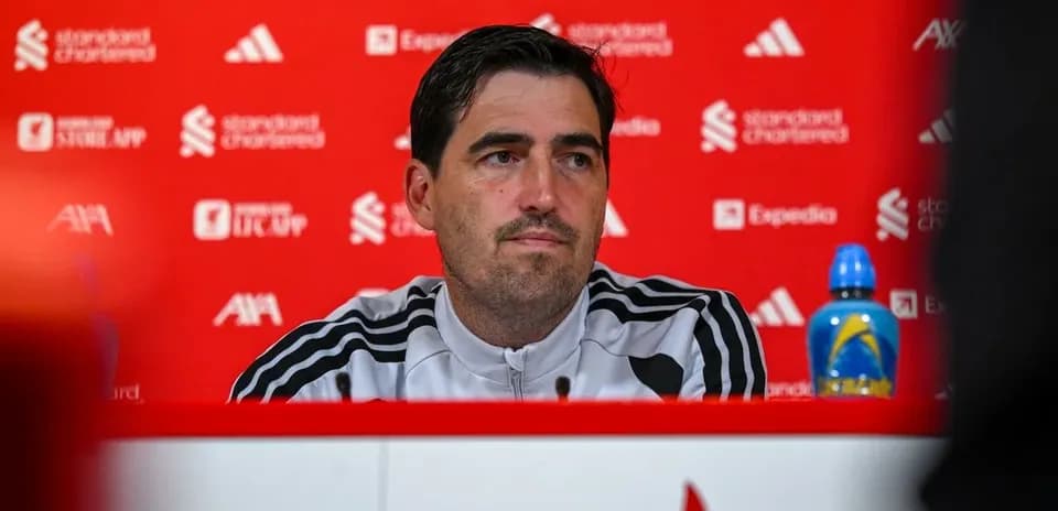 Manager at press conference with red backdrop