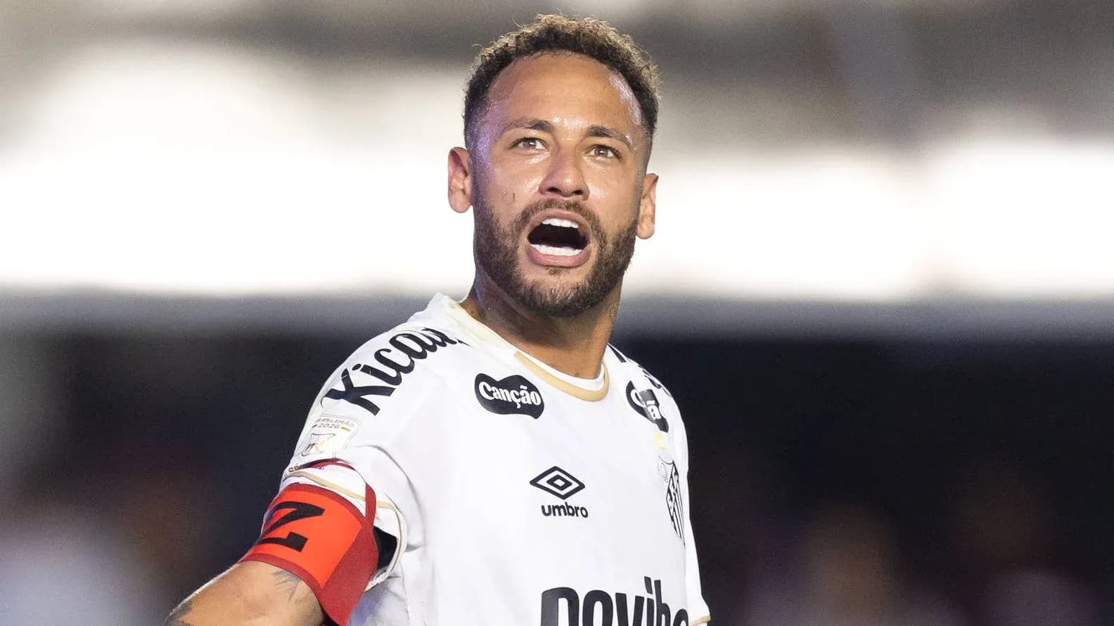 Player celebrating with captain's armband on field
