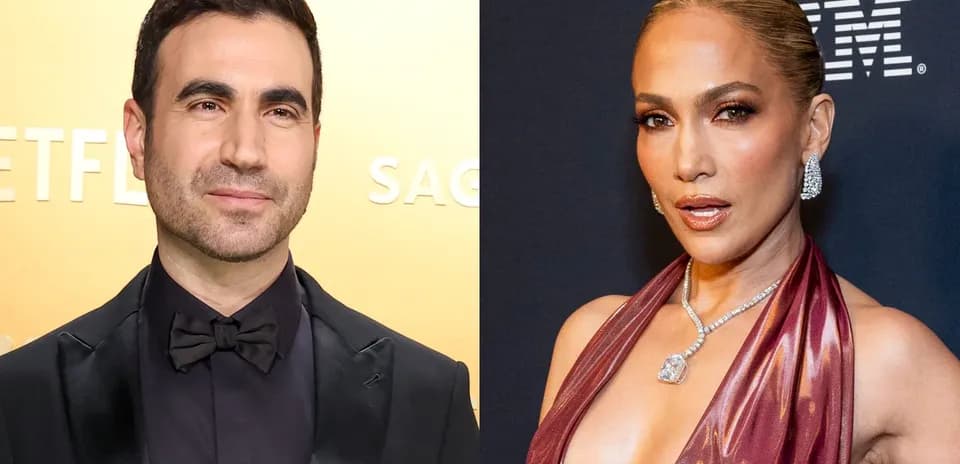 Two celebrities posing at a red carpet event