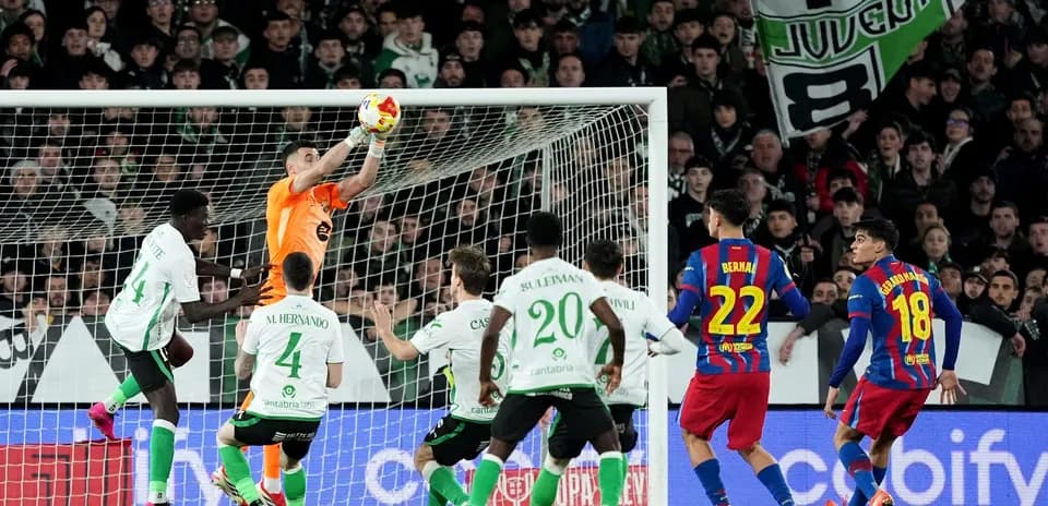 Goalkeeper catching ball during intense match action