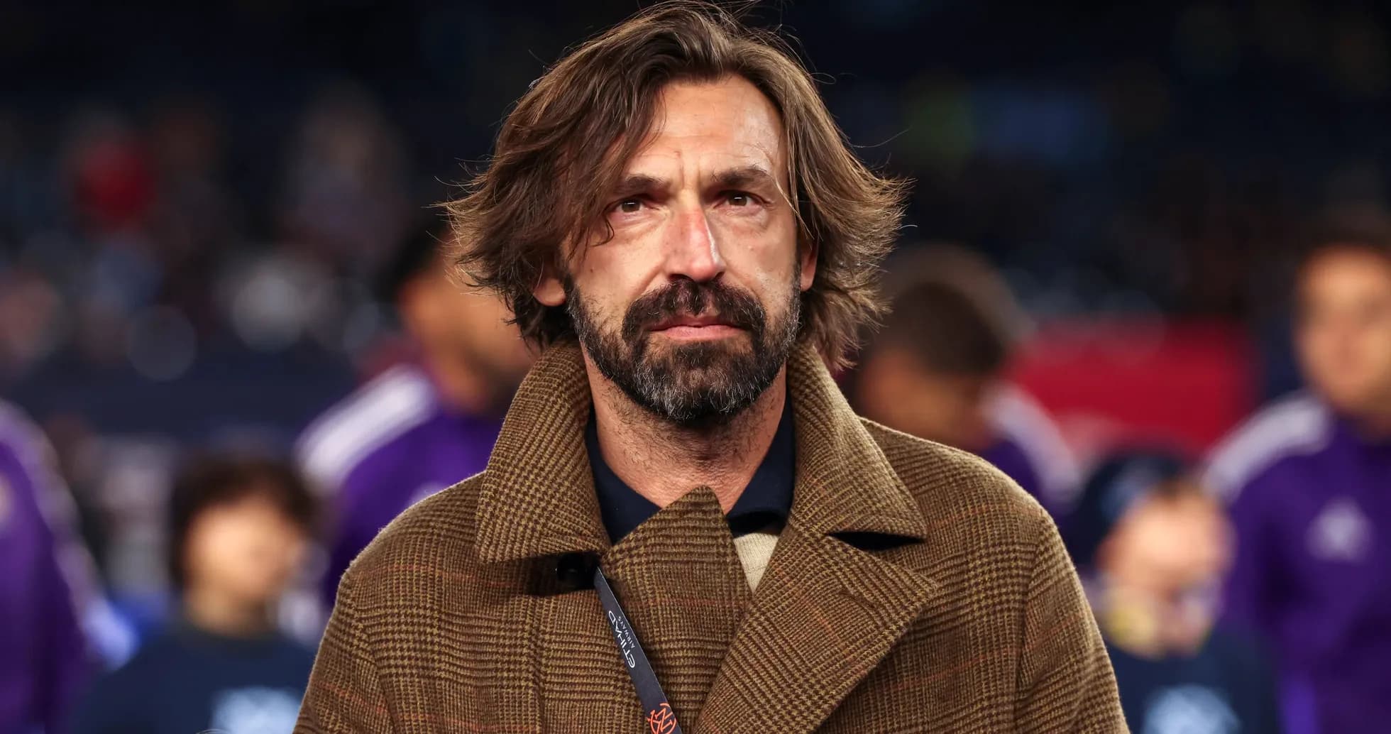 Man in brown coat at sports event