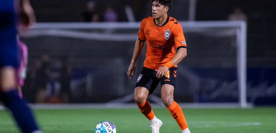 Player in orange jersey during football match