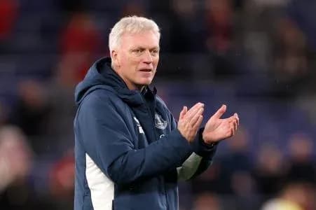 Manager clapping during a match on the sidelines