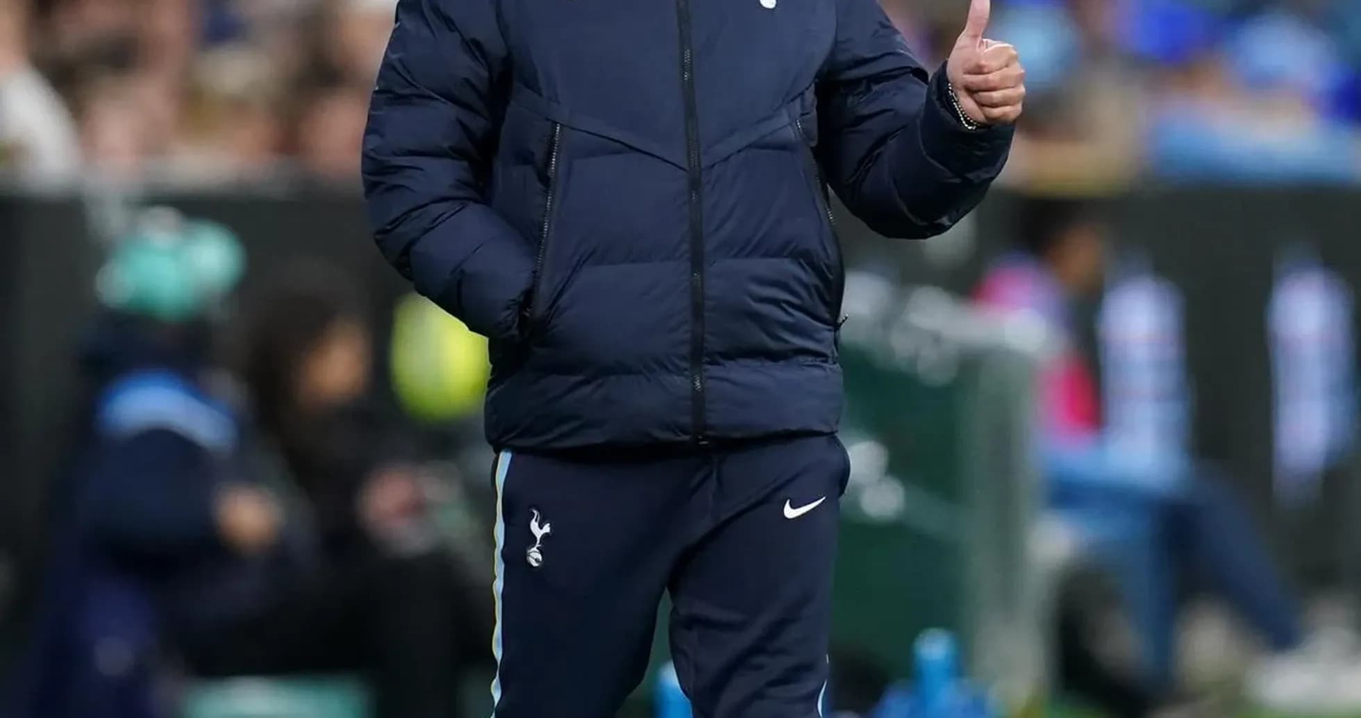 Manager giving thumbs up during match on sidelines