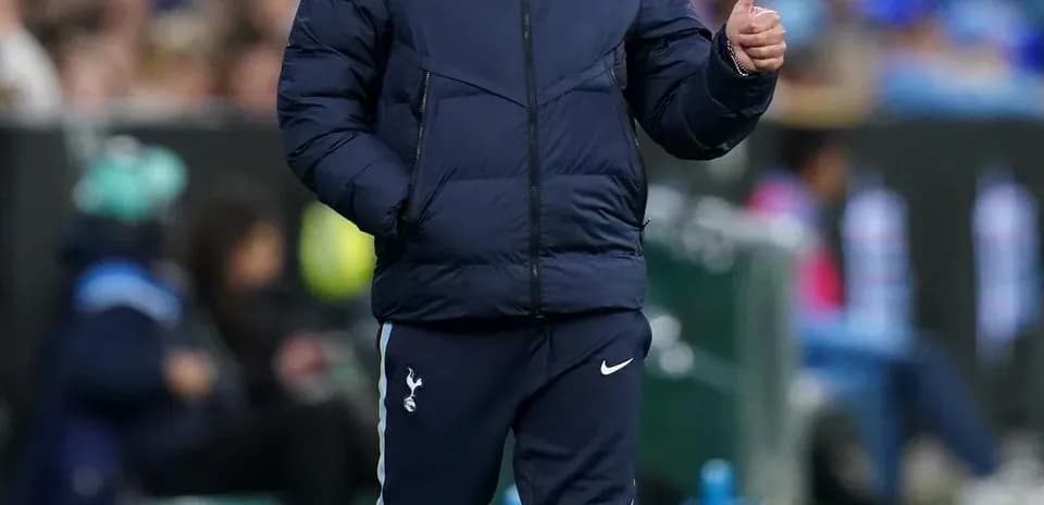 Manager giving thumbs up during match on sidelines