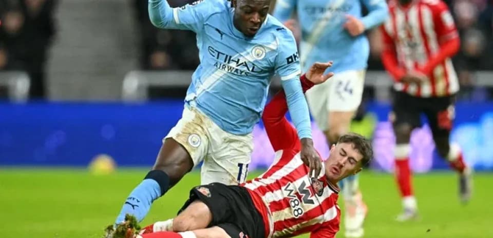 Player tackling opponent during football match action