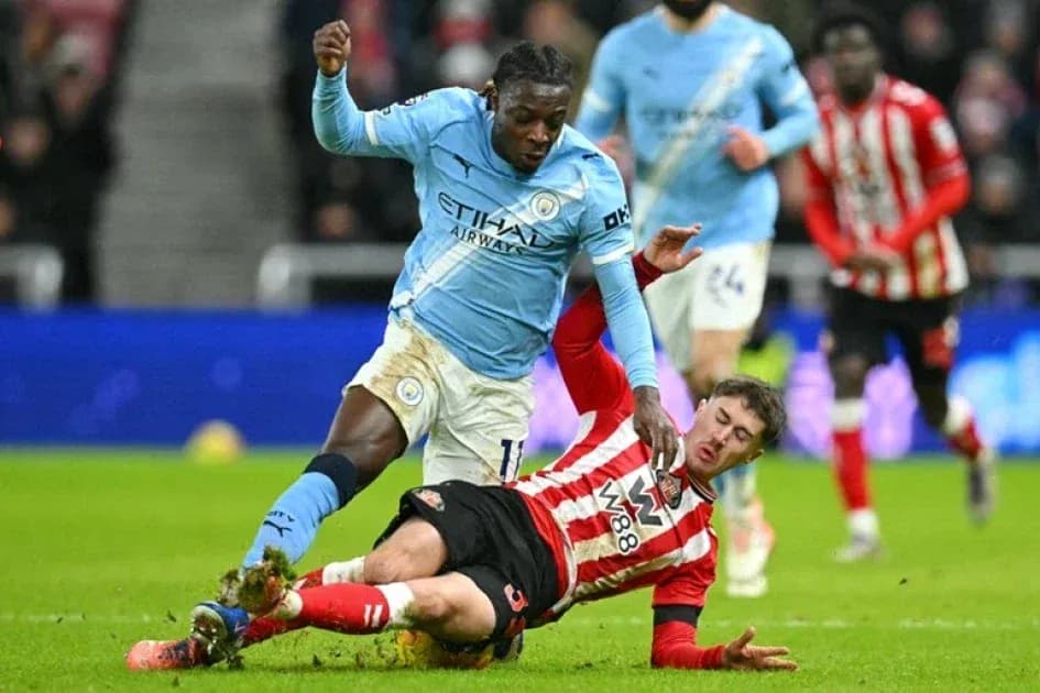 Player tackling opponent during football match action