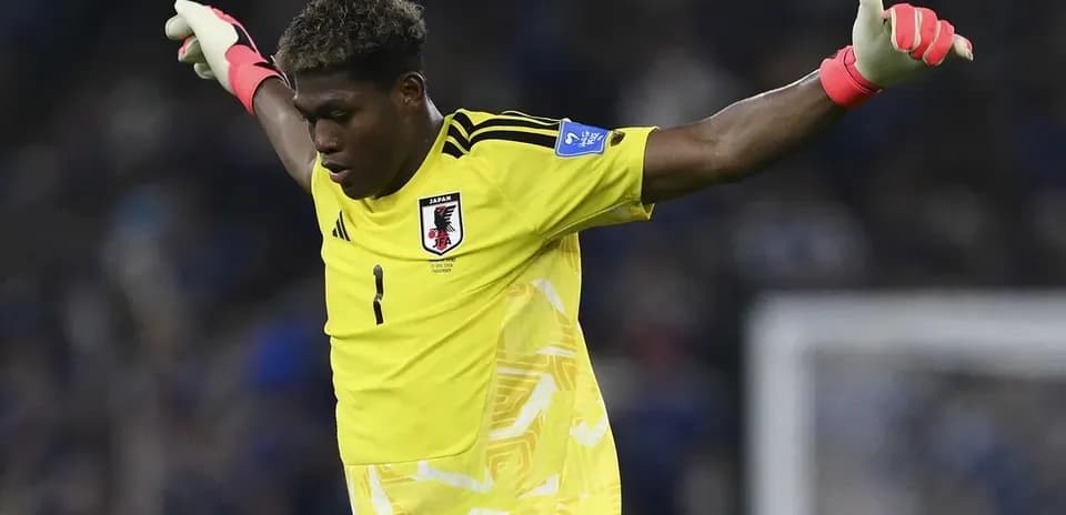 Goalkeeper in yellow kit gesturing during match