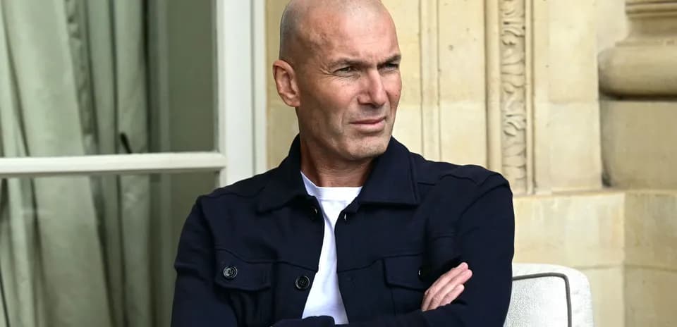 Man sitting with arms crossed in outdoor setting