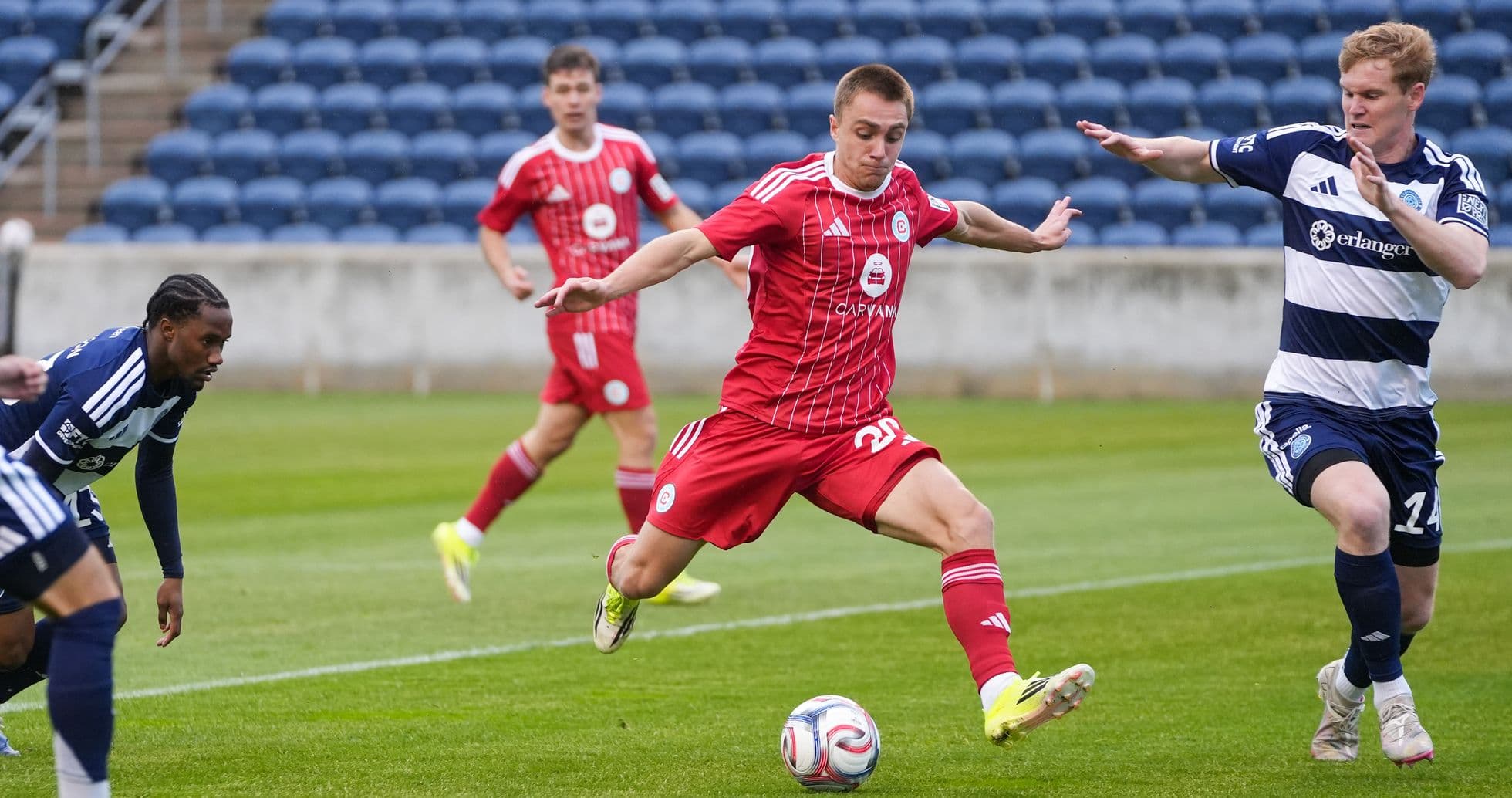 New England II player dribbling past opponents