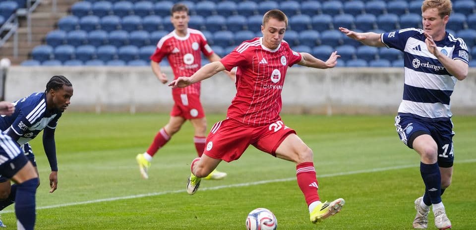 New England II player dribbling past opponents