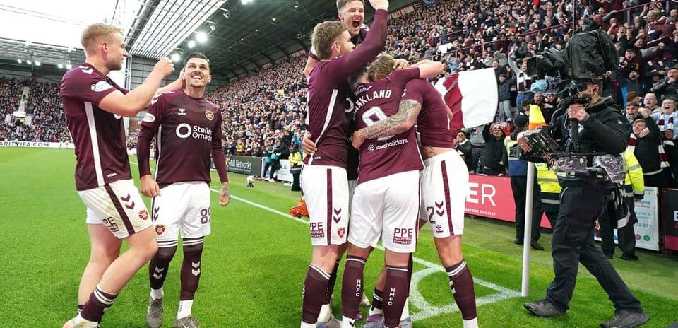 Hearts players celebrating a goal with fans