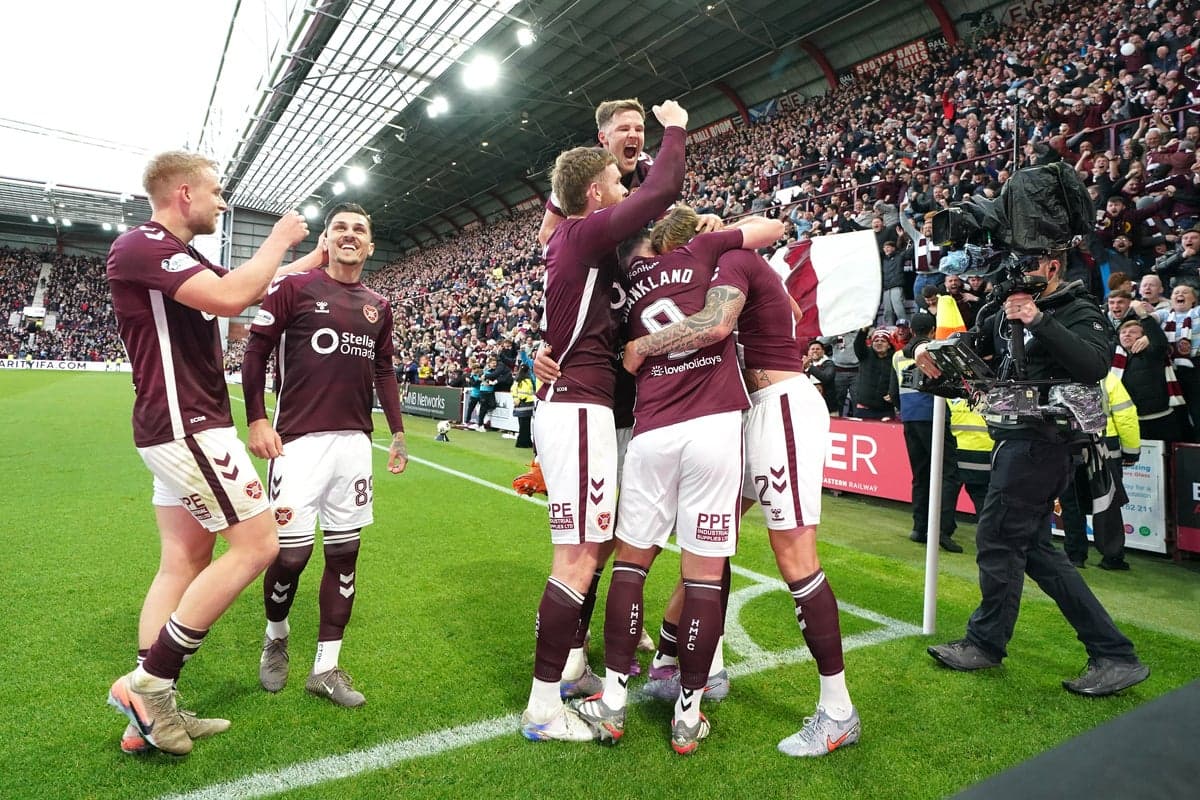 Hearts players celebrating a goal with fans
