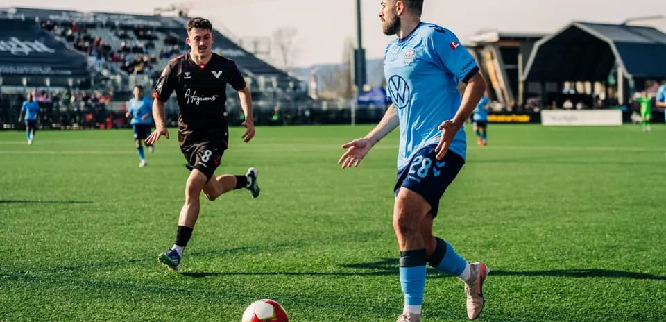 Player dribbling the ball in football match