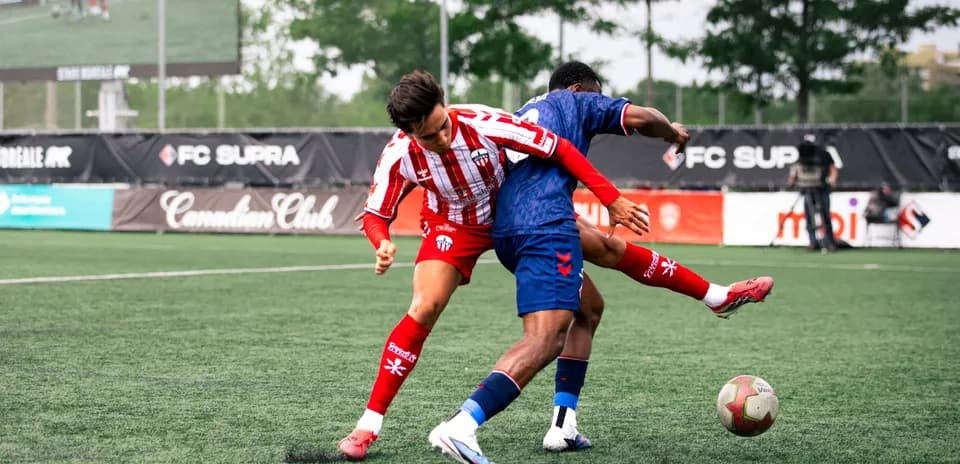 Two players competing for the ball in football match