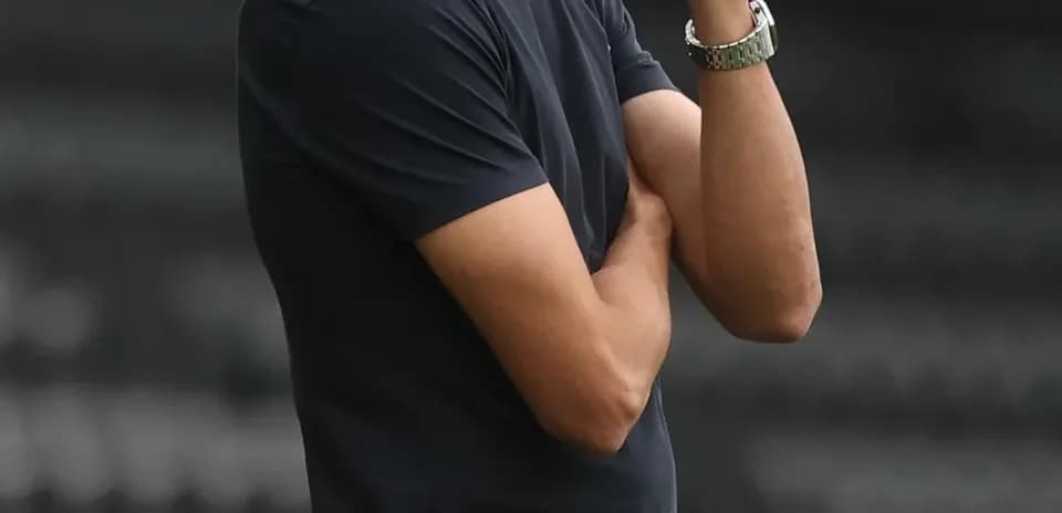 Coach observing match from the sidelines