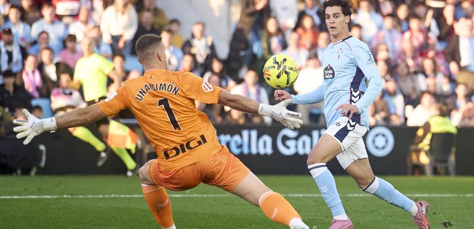 Goalkeeper attempting to block shot during match