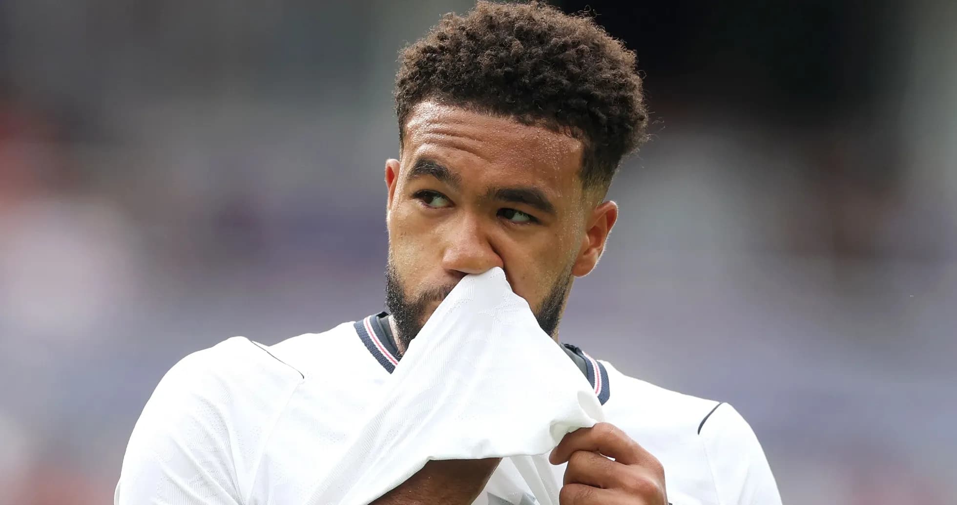 Player wiping face with shirt during match