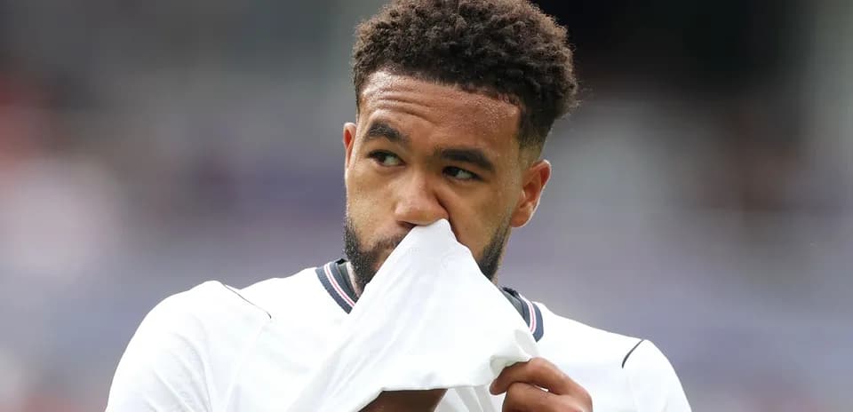 Player wiping face with shirt during match
