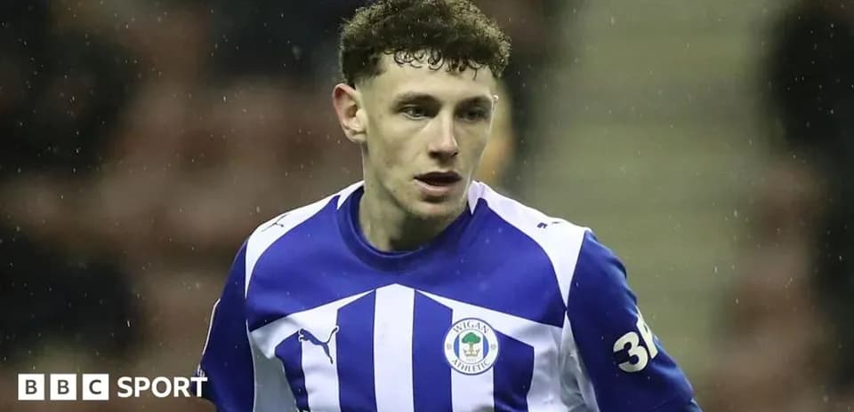 Player wearing Wigan Athletic jersey on the field