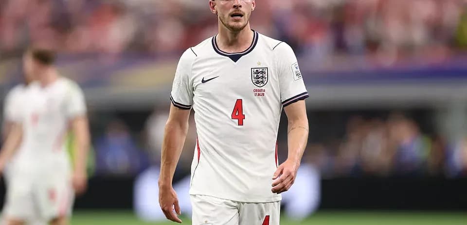 Player wearing England kit walking on the pitch