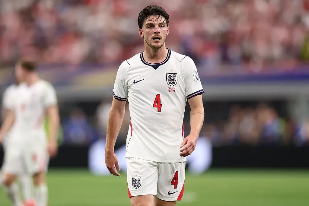 Player wearing England kit walking on the pitch