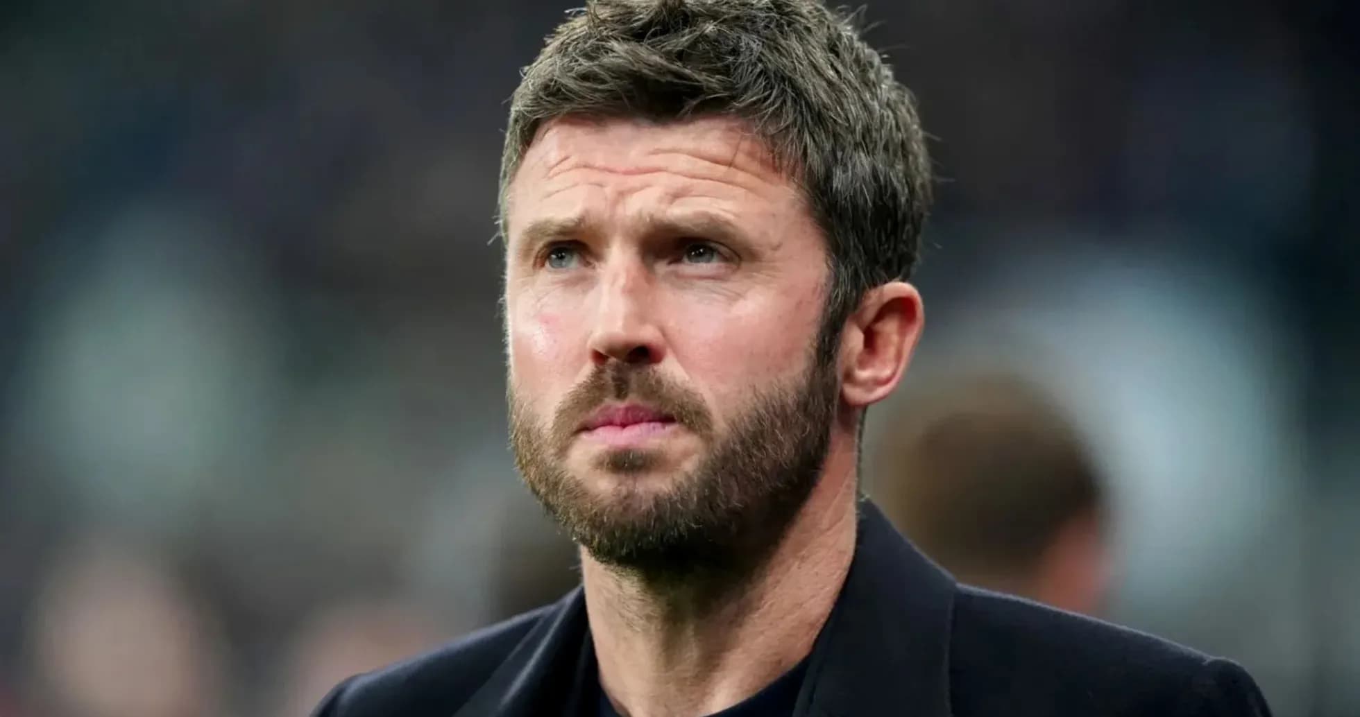 Man with beard looking thoughtfully off-camera