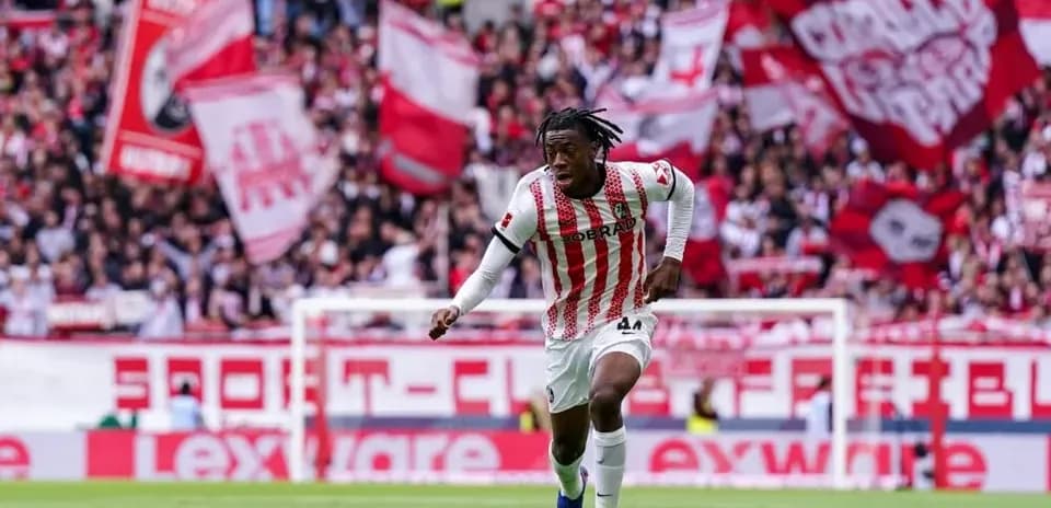 Player running with the ball in front of fans