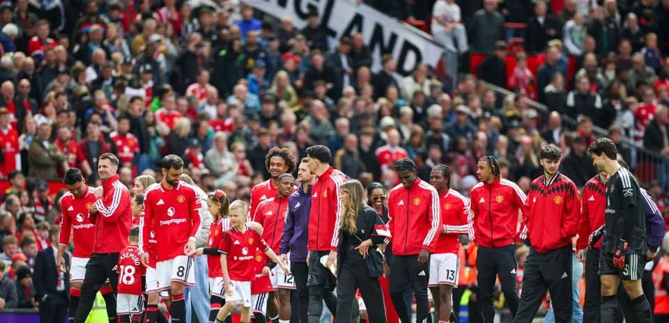 Manchester United players entering the field with fans