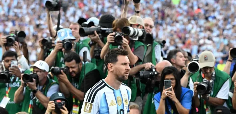 Lionel Messi surrounded by photographers at event