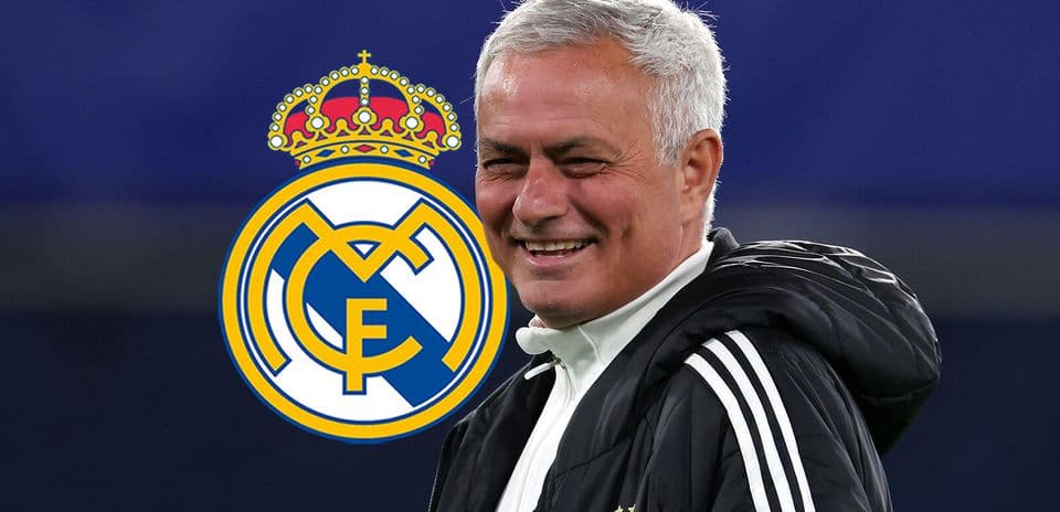 Coach smiling with Real Madrid logo background