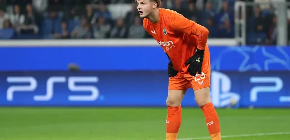 Goalkeeper in orange kit during a match