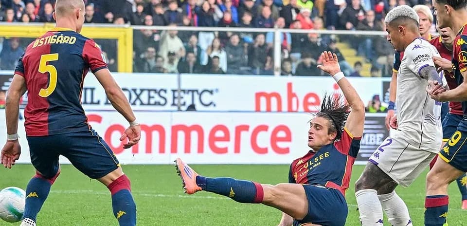 Genoa player tackles Fiorentina opponent during match