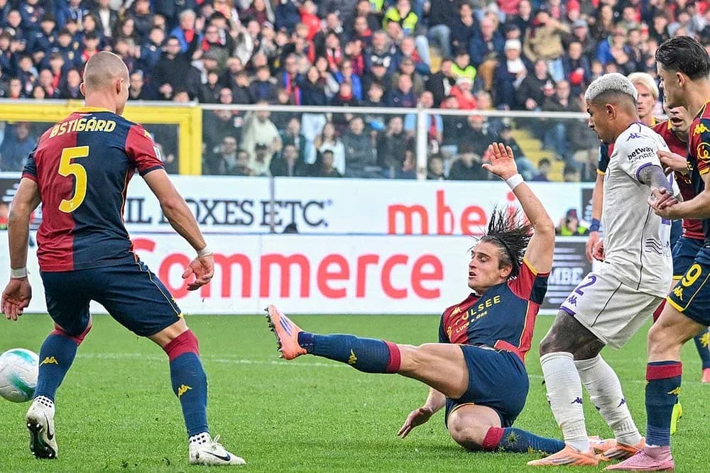 Genoa player tackles Fiorentina opponent during match