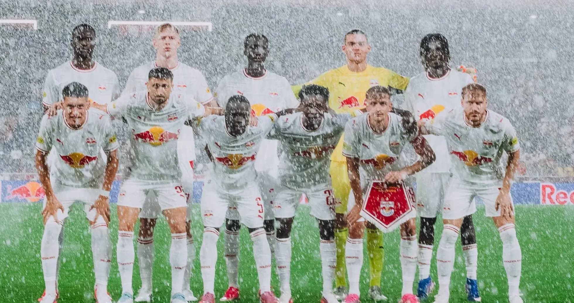 Red Bull Salzburg team posing in rain