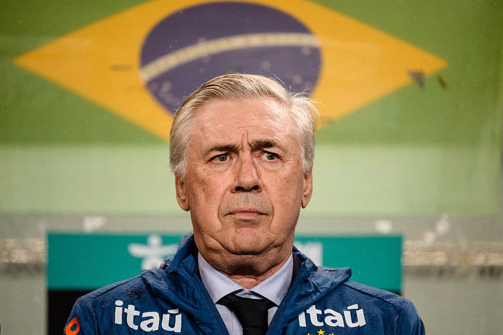 Coach standing in front of Brazilian flag backdrop