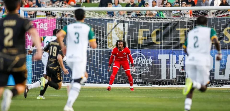 Goalkeeper preparing for penalty kick in match