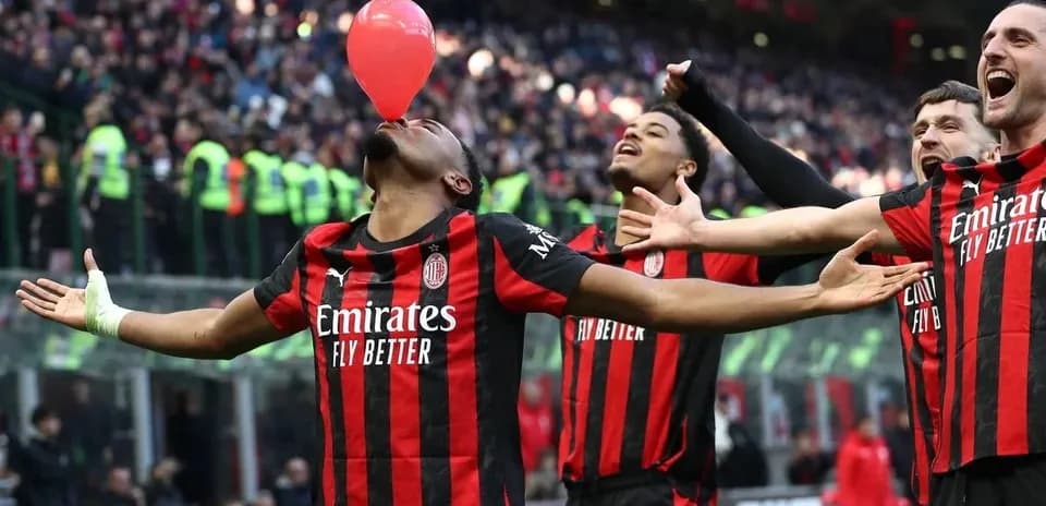 AC Milan players celebrating with a balloon