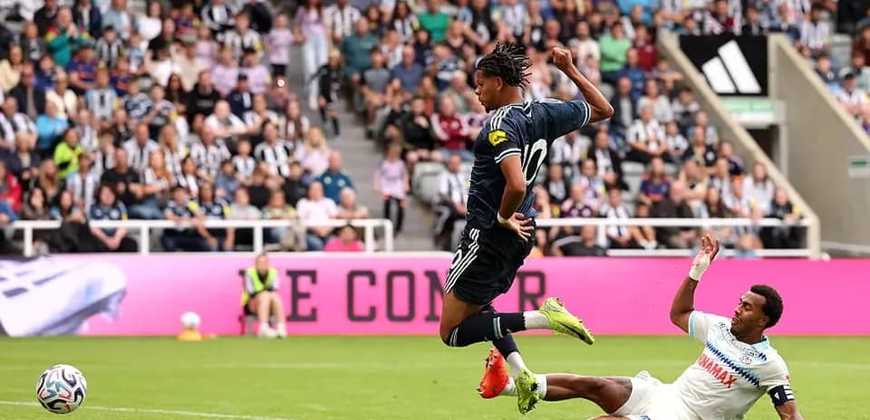 Player evading a tackle during football match