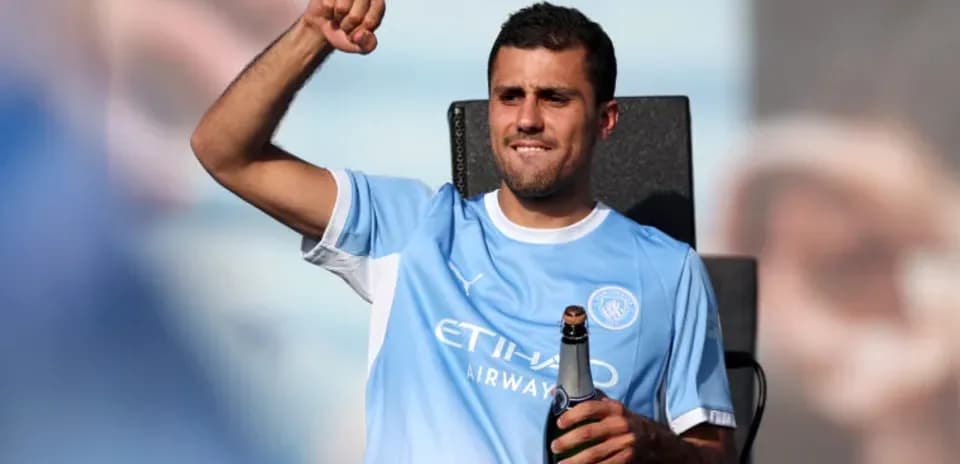 Player celebrating with champagne in team jersey