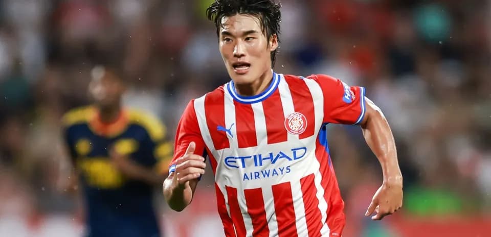 Player running with ball during match for Girona