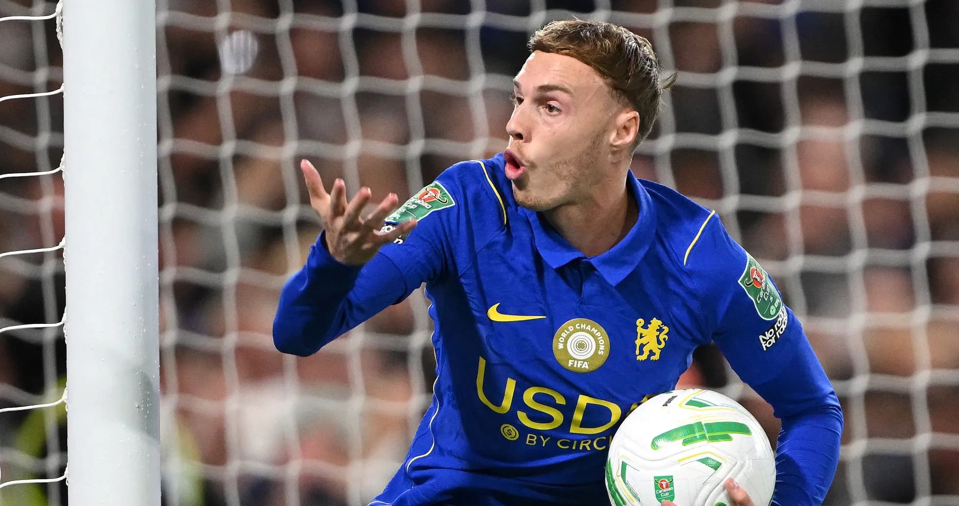 Goalkeeper in blue jersey gesturing during match