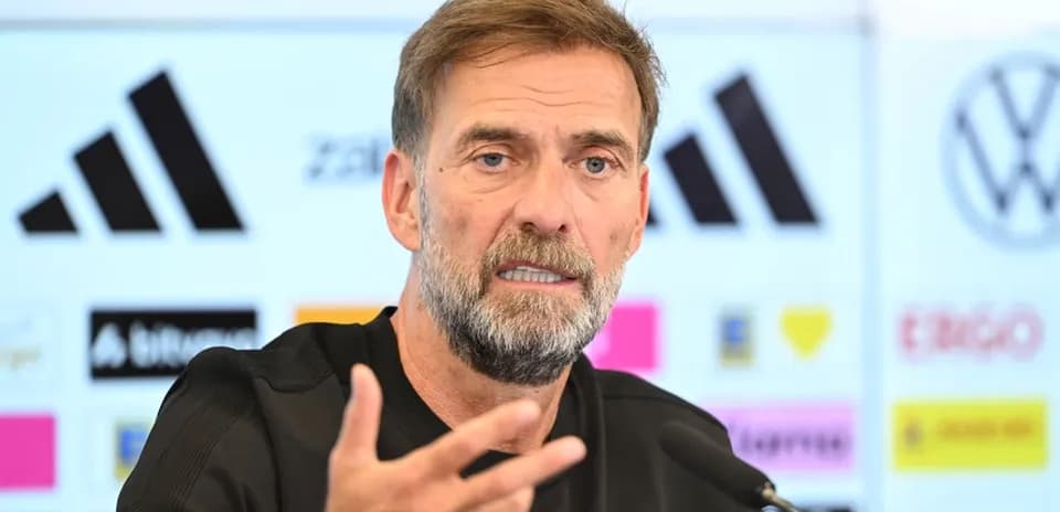 Manager speaking at press conference with microphone