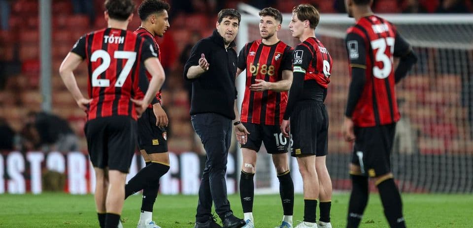 Bournemouth players discussing strategy with coach