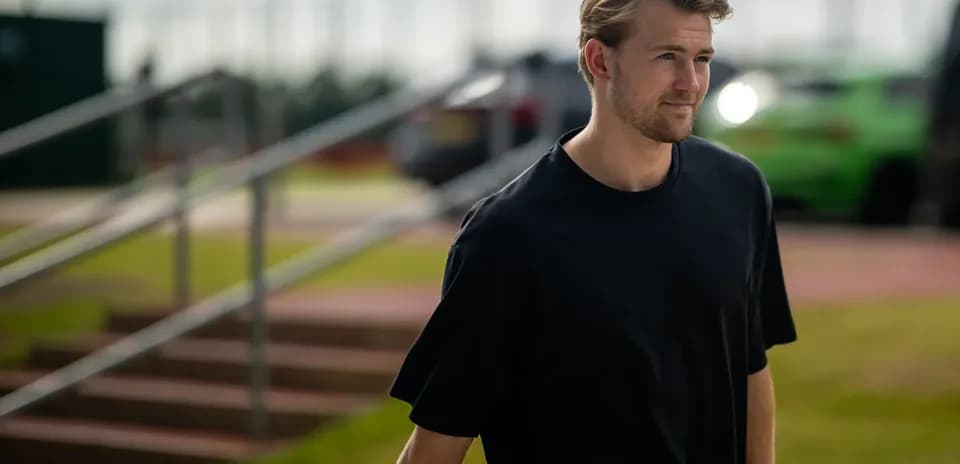 Player walking towards training facility outdoors