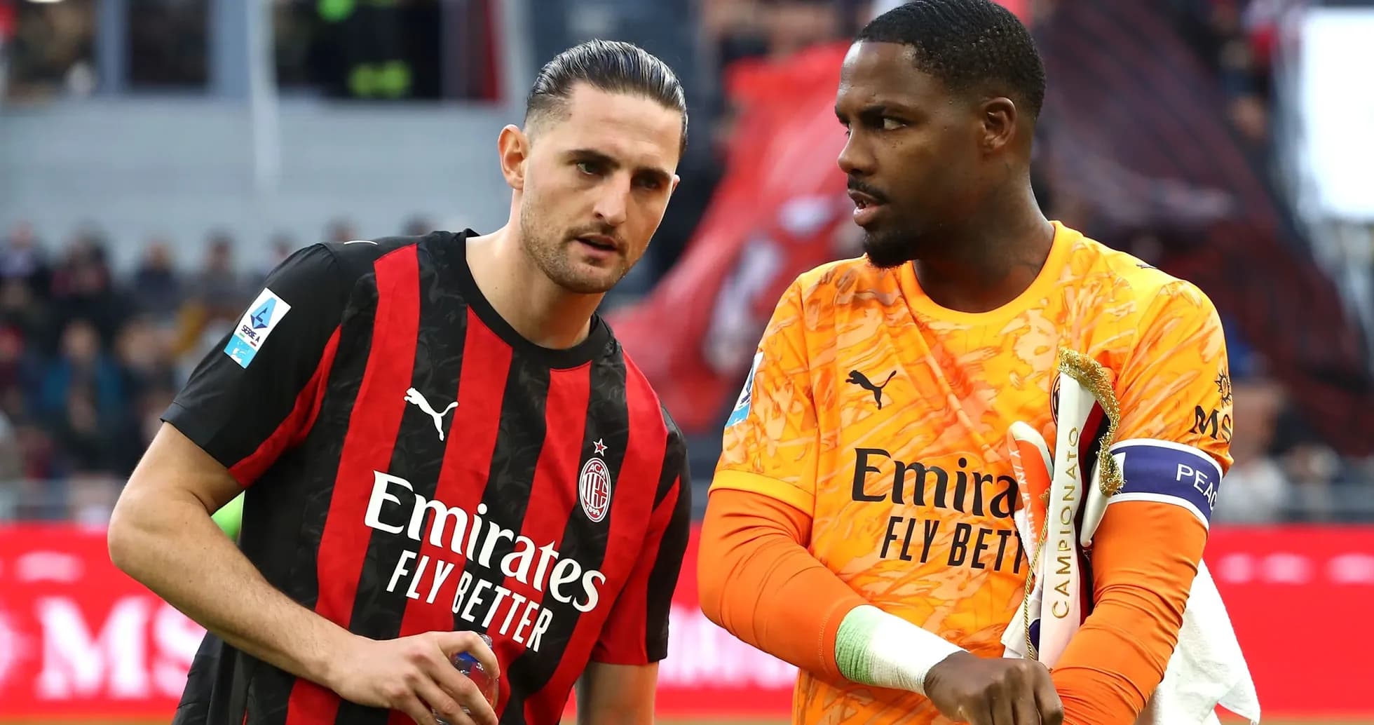 Two AC Milan players discussing on the field