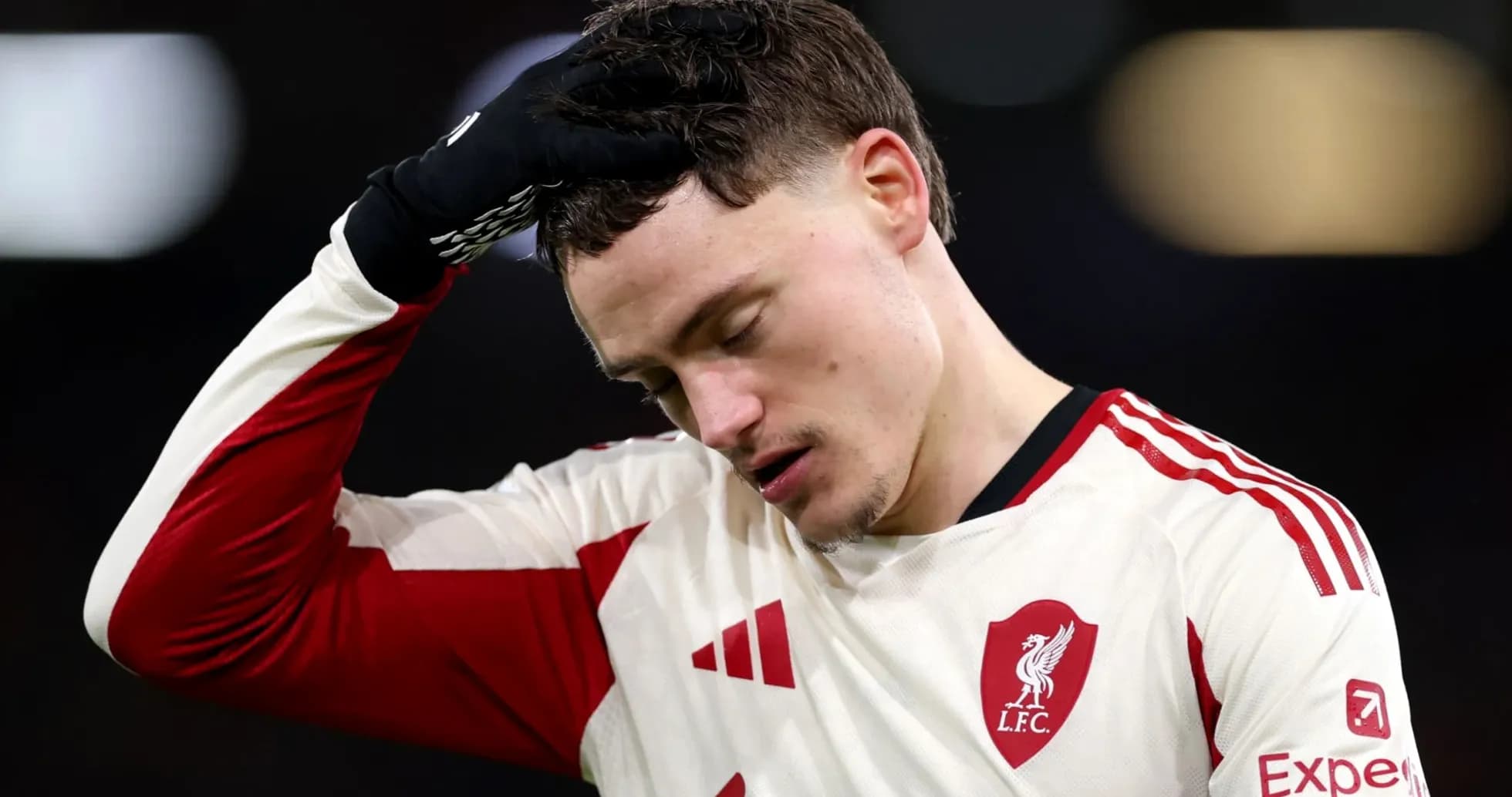 Player in Liverpool jersey looking down after match
