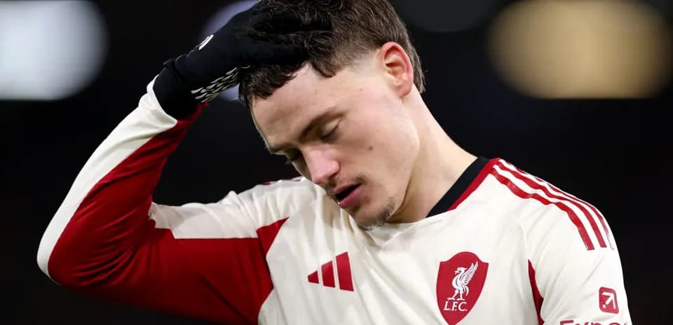 Player in Liverpool jersey looking down after match