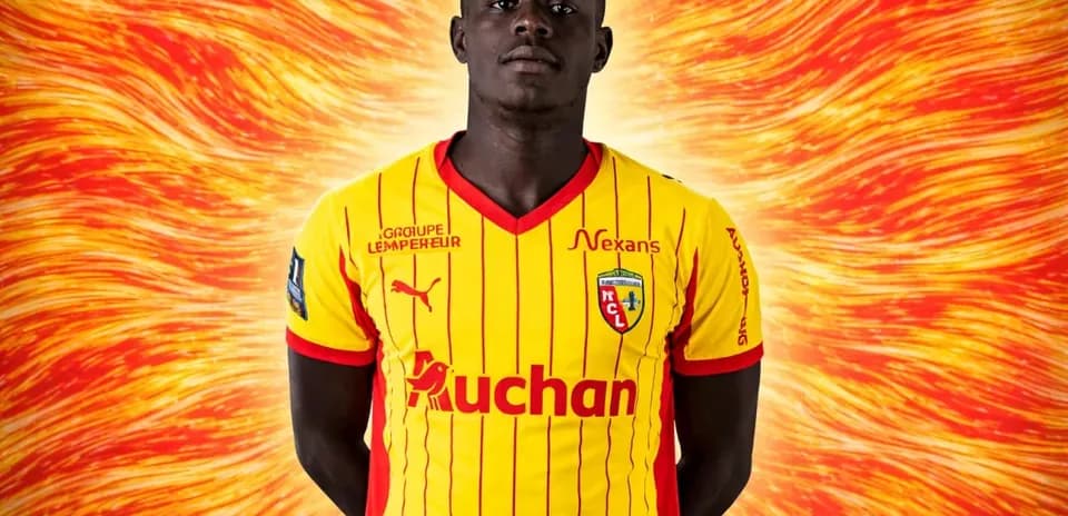 Player in yellow and red team jersey posing